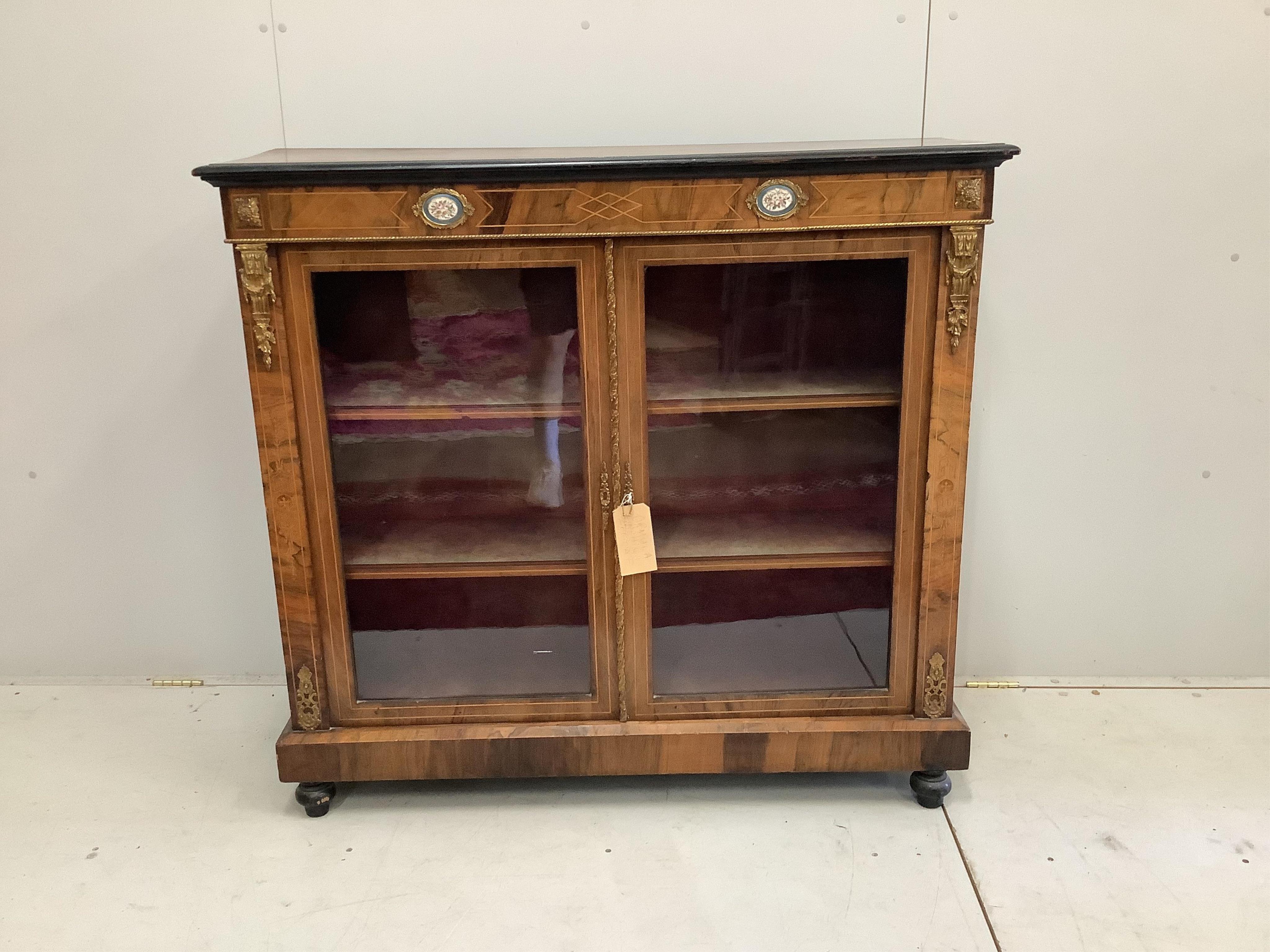 A late 19th century porcelain and gilt metal mounted walnut pier cabinet, width 120cm, depth 37cm, height 112cm. Condition - fair